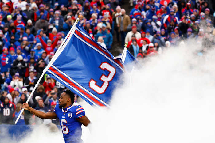 Bills players emerge from the tunnel before Patriots game with Damar Hamlin flags